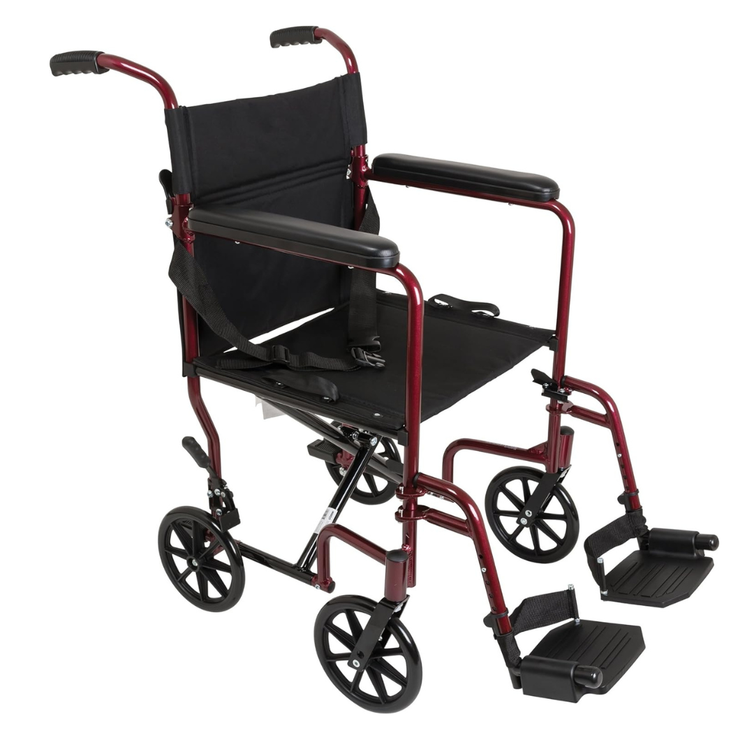 The ProBasics Aluminum Lightweight Transport Chair features a black seat and backrest, red frame, four small wheels, footrests, push handles, and folds for easy portability and storage.